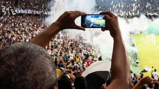 Person Taking Photo of Stage Stadium Presentation.